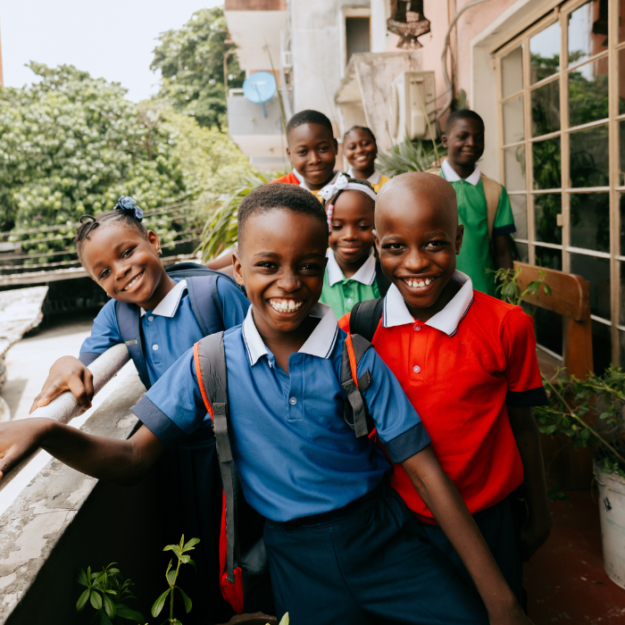 Group of smiling students helped by nonprofit initiatives.